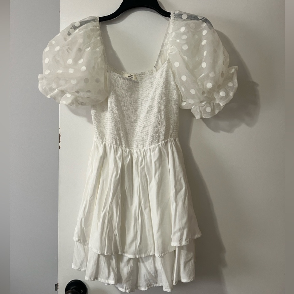 White romper with puff sleeves.